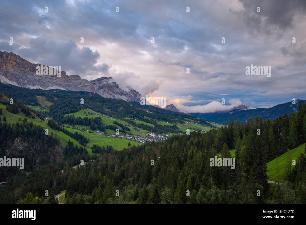 aerial view on sunset in the cloudy dolomites mountains Stock Photo