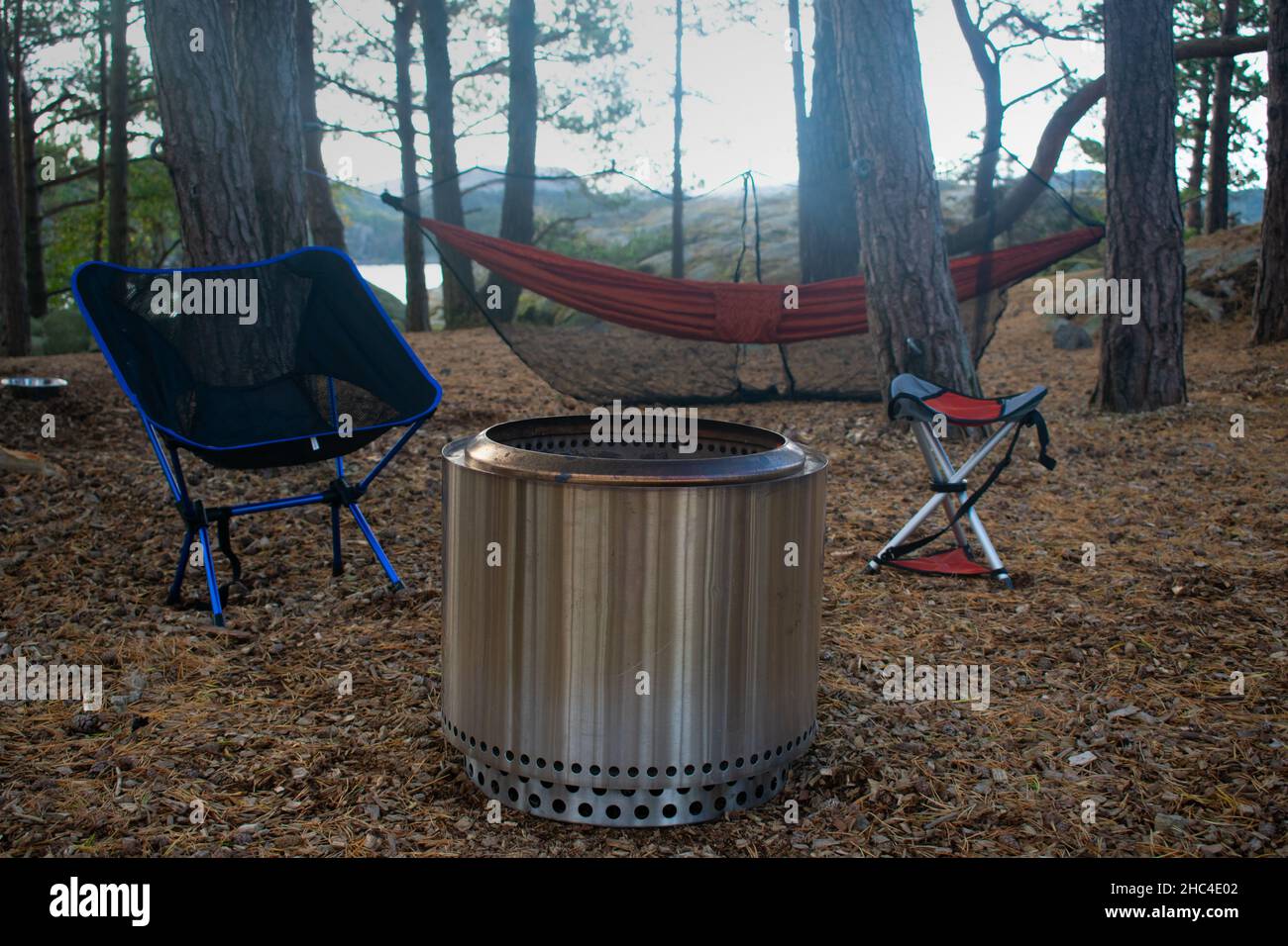 Forest Campsite with Fire Pit, Camp Chairs, and Hammock in Stavanger