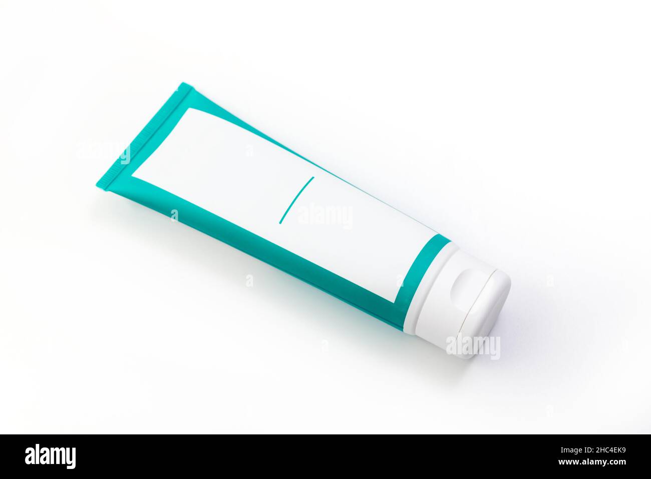 Cosmetic cream green tube. Sskincare cosmetic package. Plastic toothpaste tube. Product in green tubeisolated on white background. Clipping path inclu Stock Photo