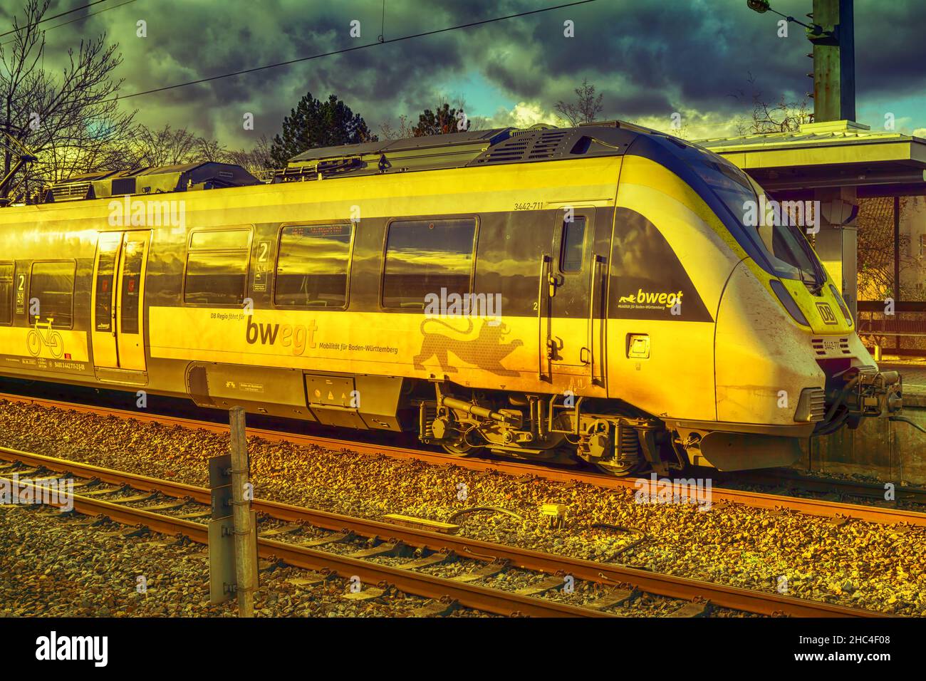 Waiblingen,Germany,December 05,2021:Train station A yellow and white train of BWegt was stopping at the small,old station. Stock Photo
