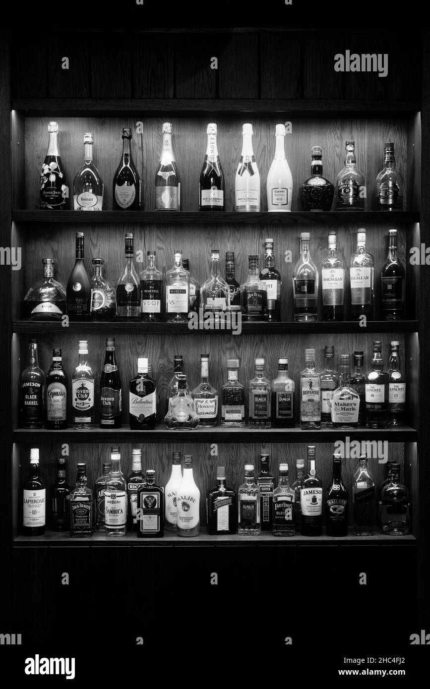 Bottles With Alcoholic in a bar. Bottles of alcoholic beverages are on the shelves. Bar on the wall. 06.06.2021, Rostov region, Russia. Stock Photo