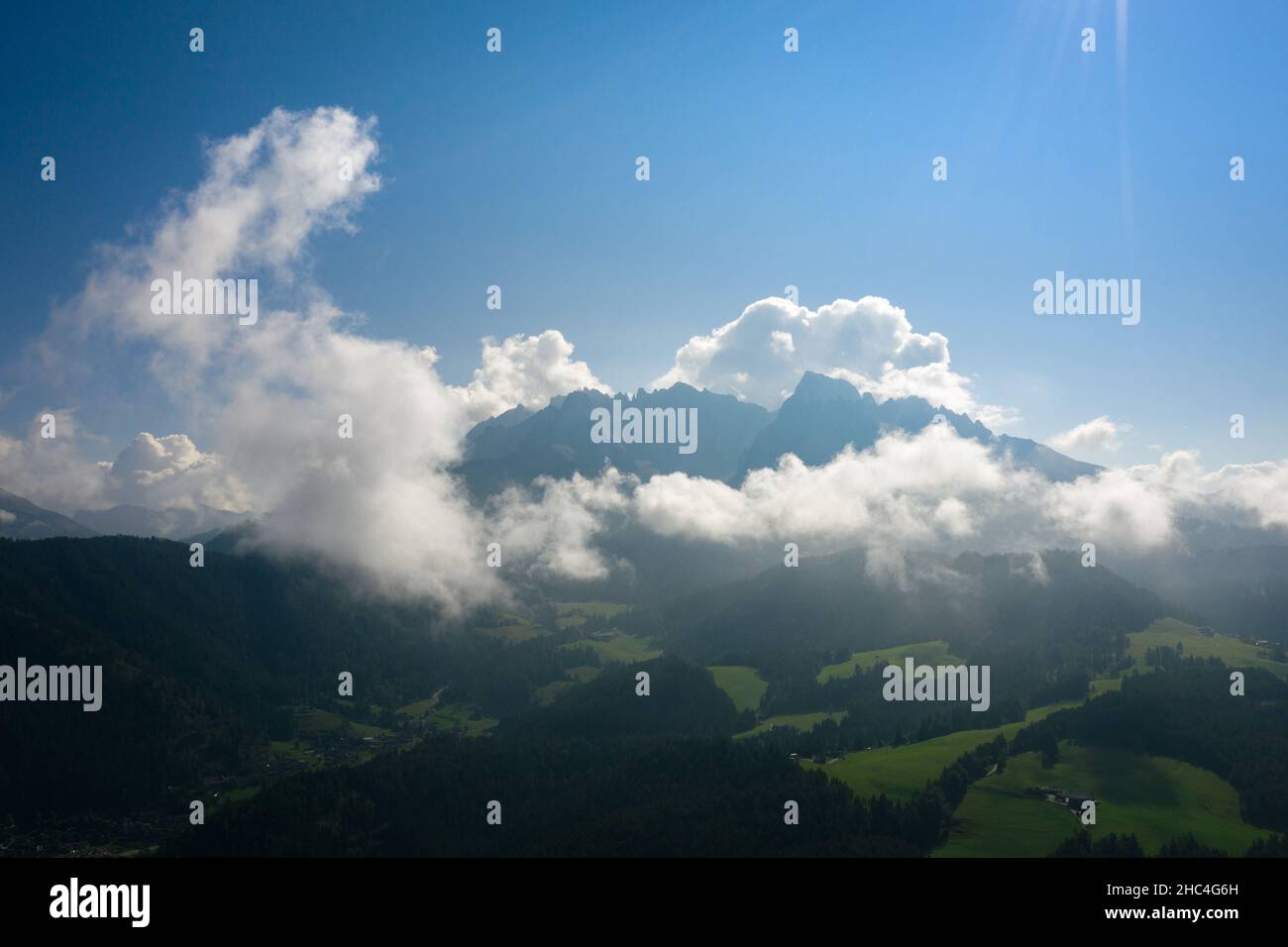 aerial view of latemar mountains covered in clouds in the dolomites on a sunny day Stock Photo