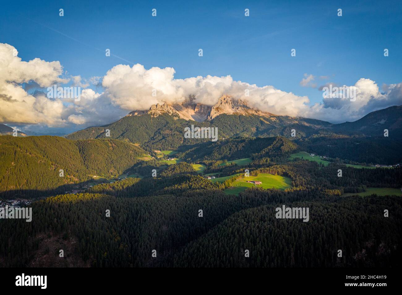 aerial view on cloudy dolomites mountains latemar during sunny day Stock Photo