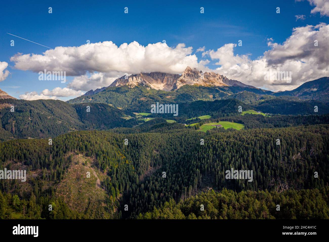 aerial view on cloudy dolomites mountains latemar during sunny day Stock Photo
