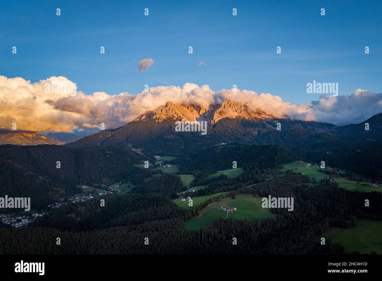 aerial view on sunset on cloudy dolomites mountains latemar Stock Photo