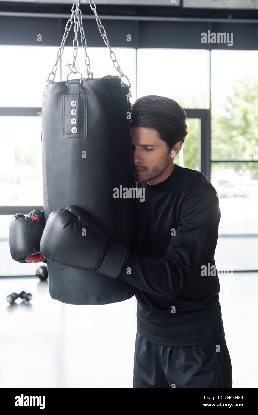 Boxing Hug Lock Man hugging punching bag hi-res stock photography and images - Alamy