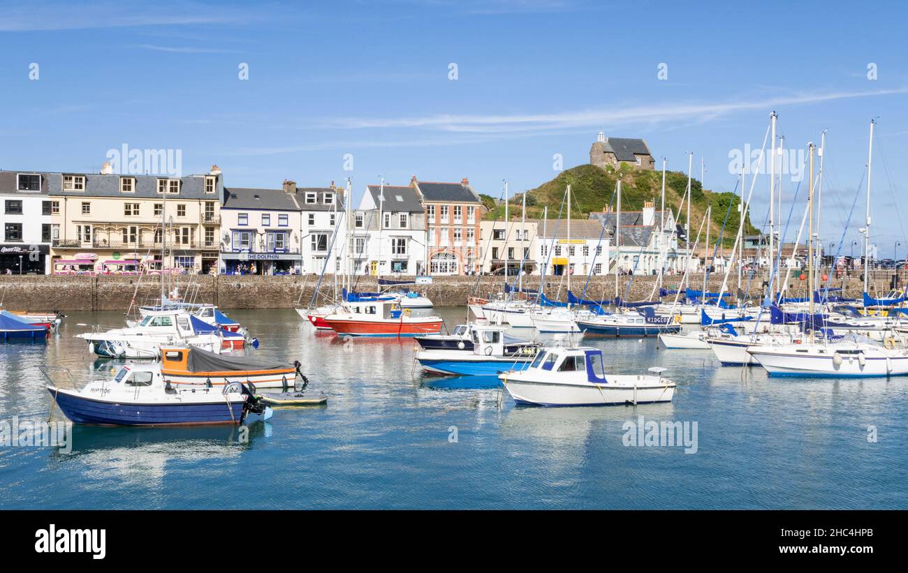 The Chapel of St Nicholas above the fishing boats and yachts in the harbour and town of Ilfracombe Devon England UK GB Europe Stock Photo