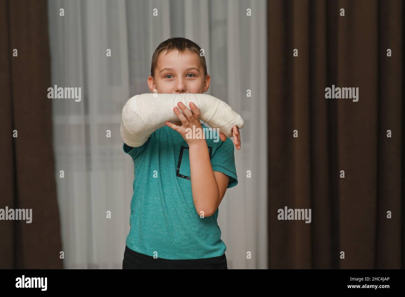 the boy's arm is in a cast. a child with a broken arm. Stock Photo