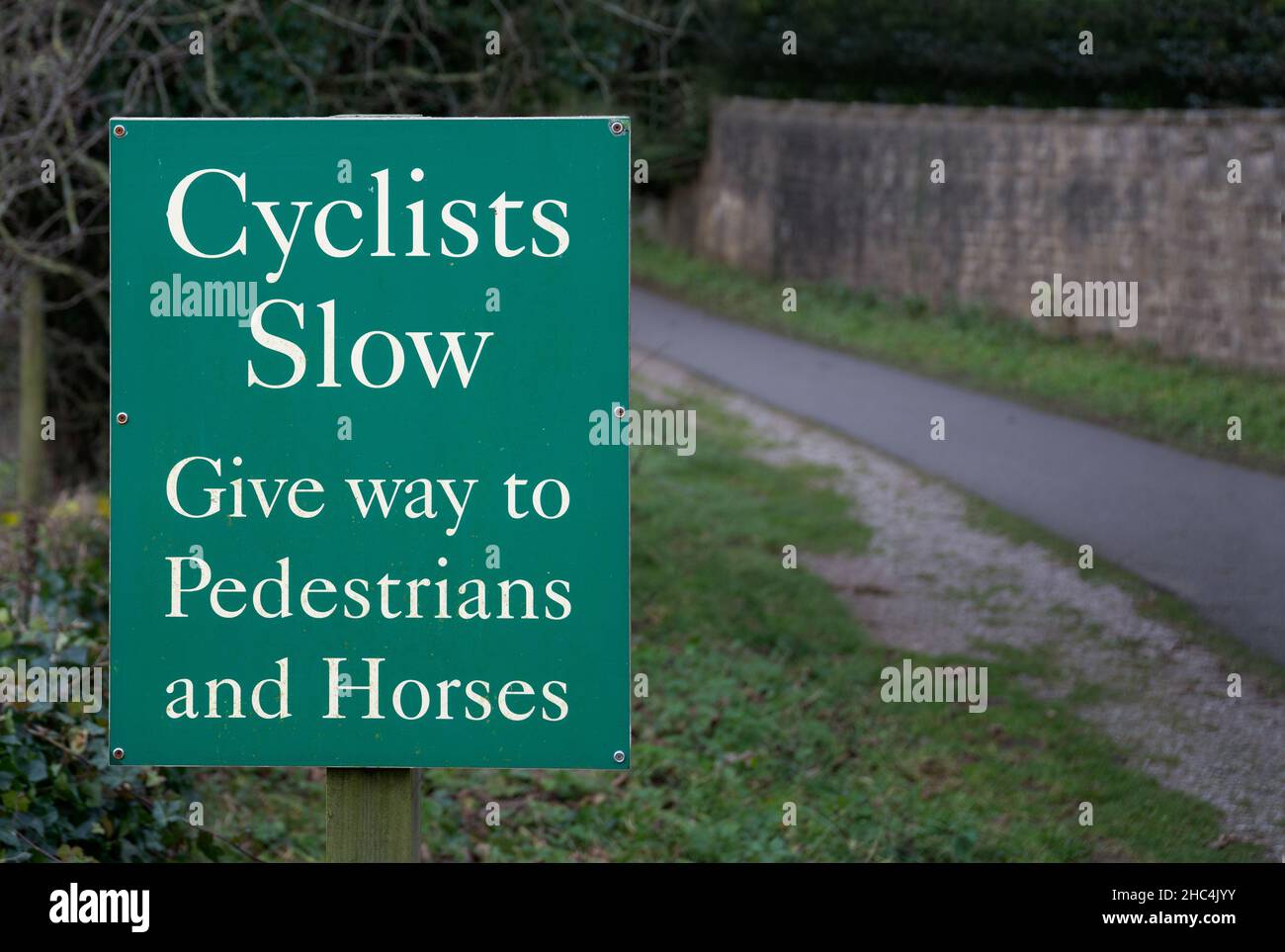 Sign - Cyclists Slow - Give Way to Pedestrians and Horses Stock Photo