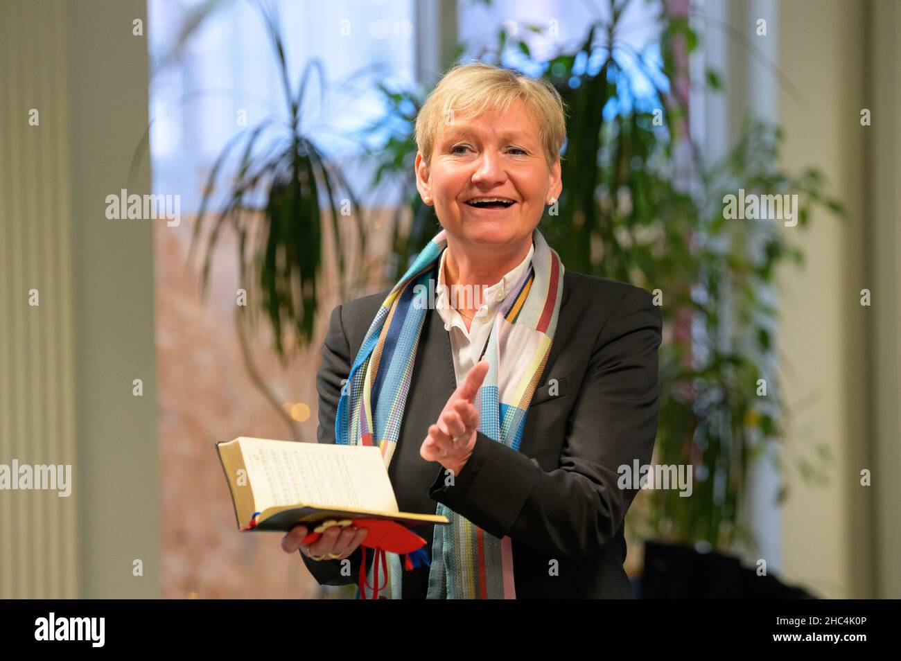 Hamburg, Germany. 24th Dec, 2021. Hamburg's Bishop Kirsten Fehrs reads the biblical Christmas story at a devotion in a facility for homeless people on Christmas Eve. Credit: Jonas Walzberg/dpa/Alamy Live News Stock Photo