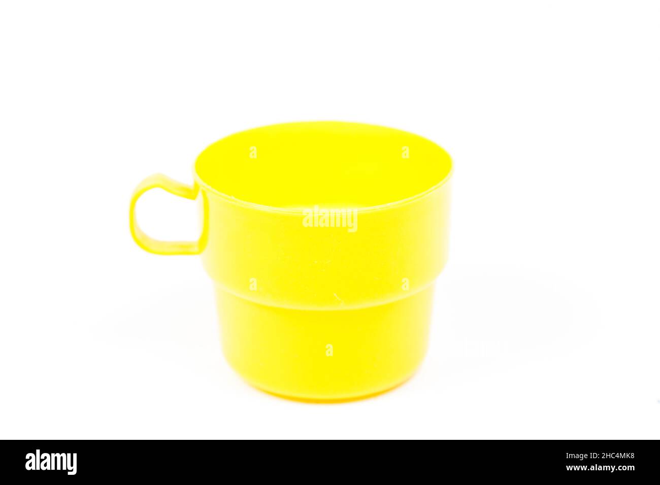 yellow plastic glass on white isolated background.object on white isolated backgruond packshot. Stock Photo