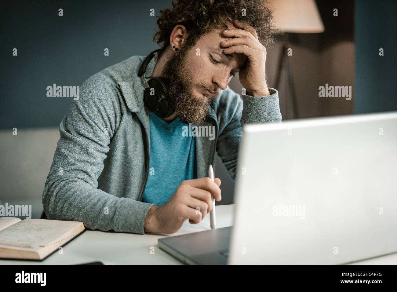 Young Man Makes On His Laptop a Business Plan For the Implementation of His Business. Manager Creates More Effective Methods For Attracting New Customers. Close-up. High quality photo Stock Photo