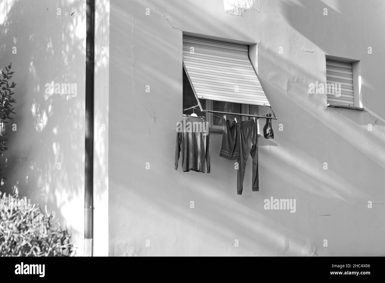 Clothes, towels and bed sheets hanging out of the window to dry (Pesaro, Italy, Europe) Stock Photo