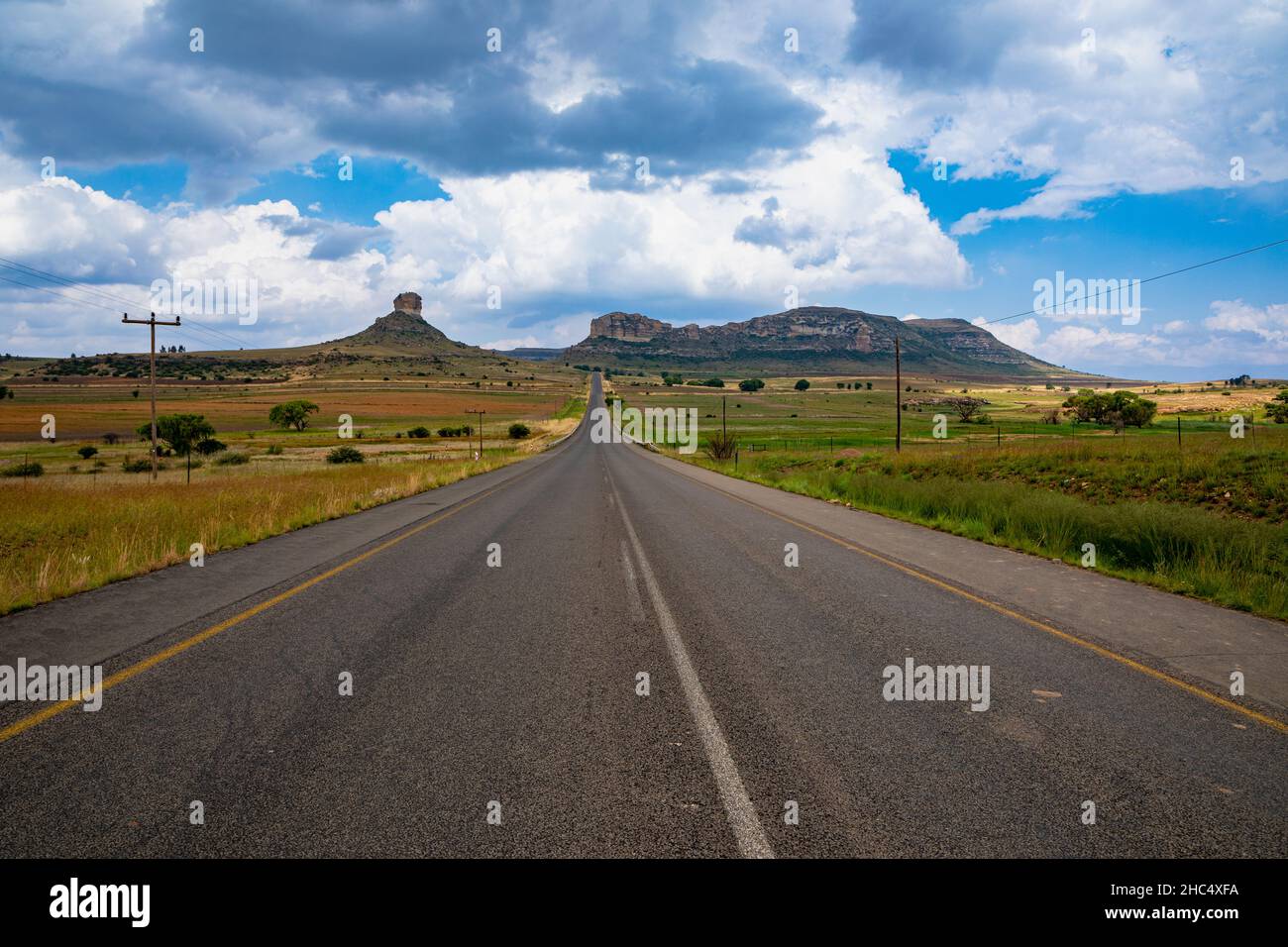 Landscape in the Eastern Freestate of South Africa with an empty road and rock formations. This road is between the towns of Clarens and Fouriesburg Stock Photo