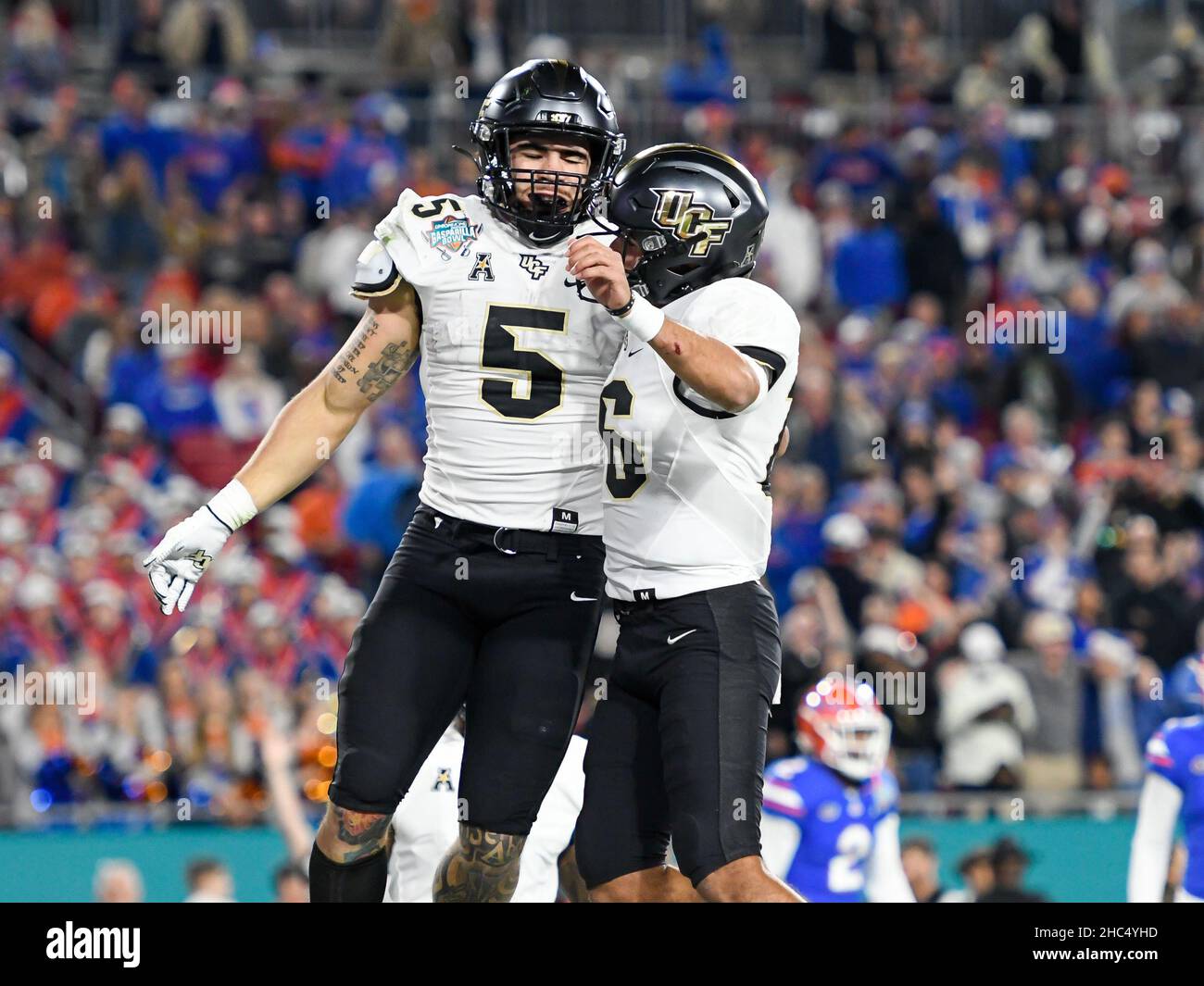 Tampa, FL, USA. 23rd Dec, 2021. UCF Knights running back Isaiah Bowser (5) celebrates after scoring with quarterback Mikey Keene (16) during the 1st half of Union Home Mortgage Gasparilla Bowl between the Florida Gators and the UCF Knights at Raymond James Stadium in Tampa, FL. Romeo T Guzman/CSM/Alamy Live News Stock Photo