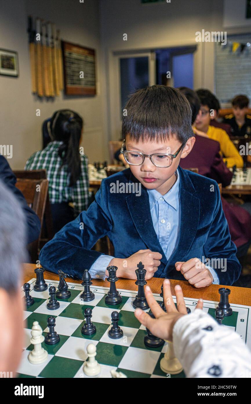 Smart games. A child plays chess. Boy and a chessboard. Strategy. Logical thinking. Stock Photo