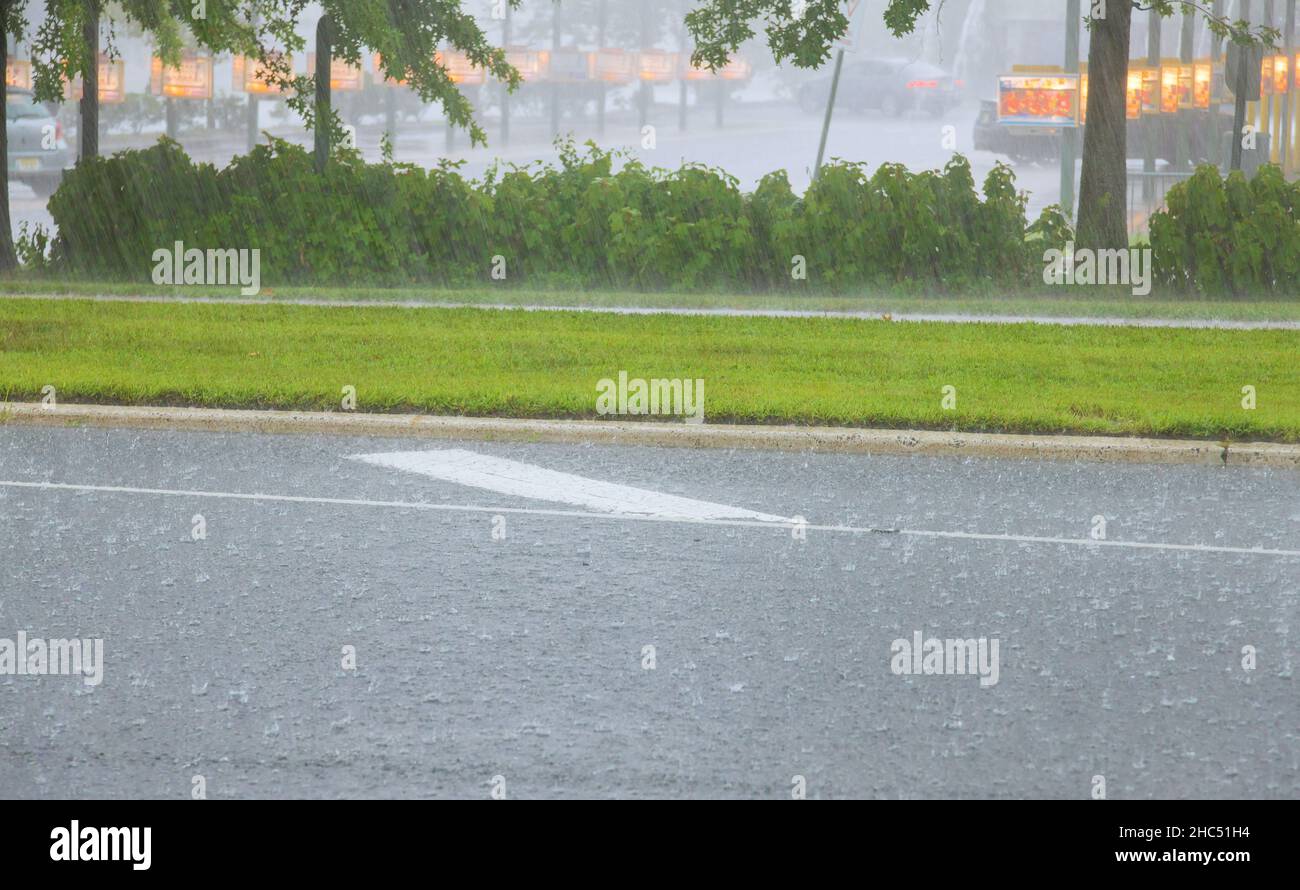 Rain water flowing from apartment building during heavy rain Stock