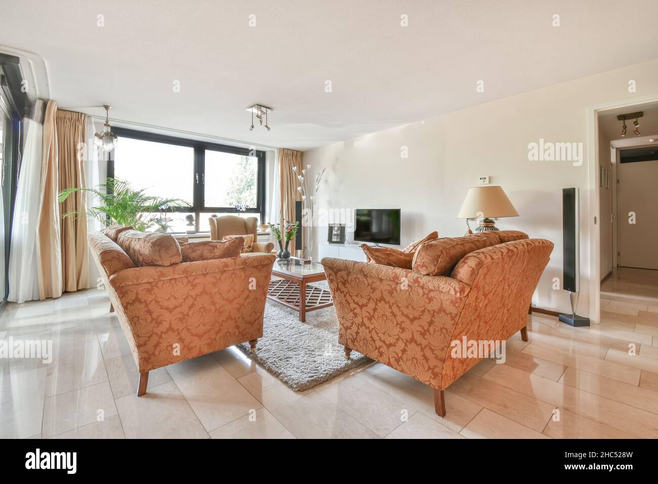 Stylish living room with vintage sofas and armchair Stock Photo - Alamy