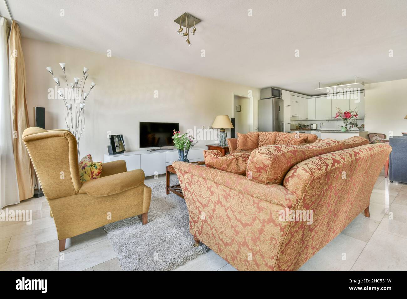 Stylish living room with vintage sofas and armchair Stock Photo - Alamy