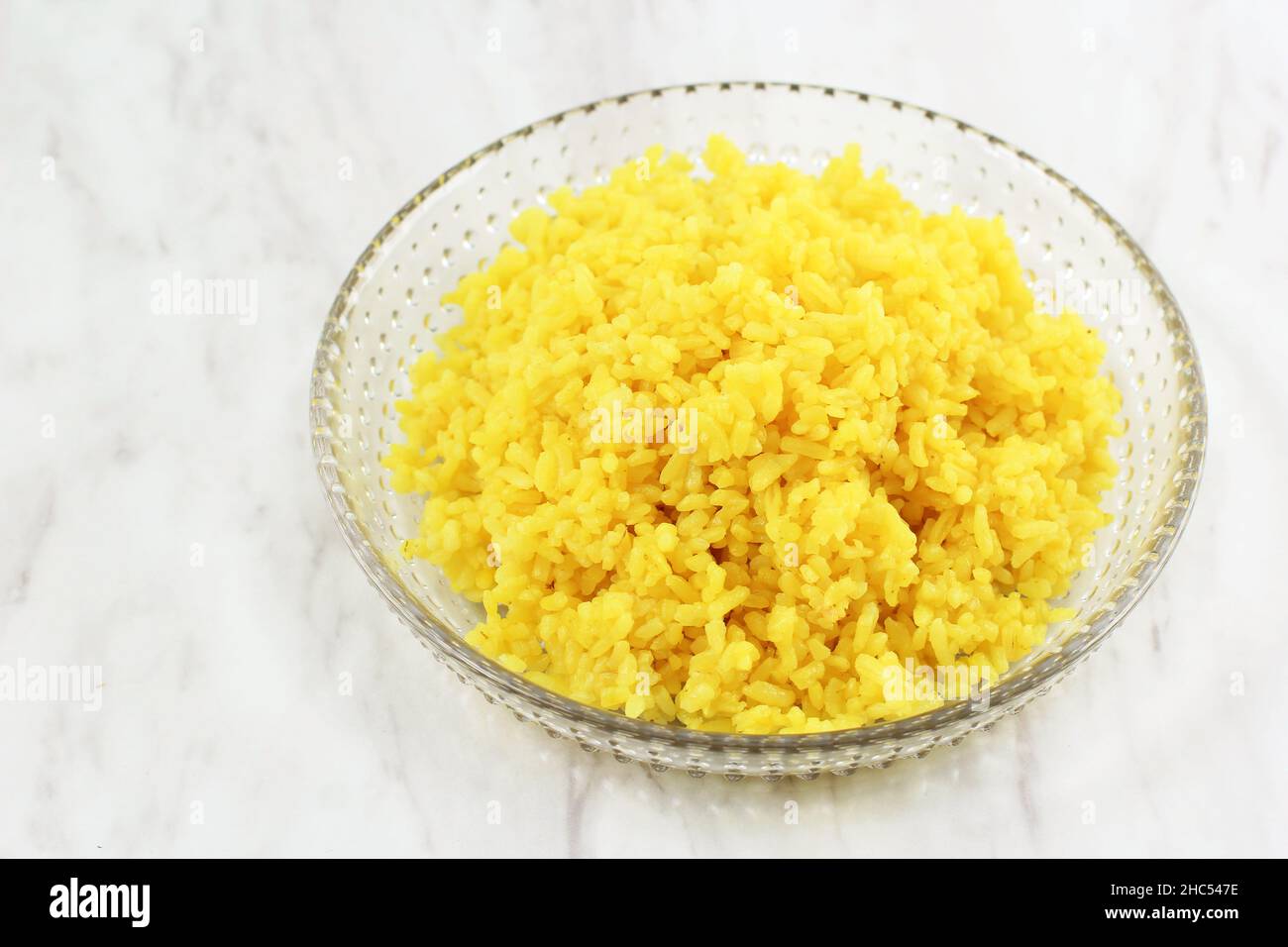 Cooked Yellow Rice in a Bowl, a Portion of Cooked Yellow Rice in