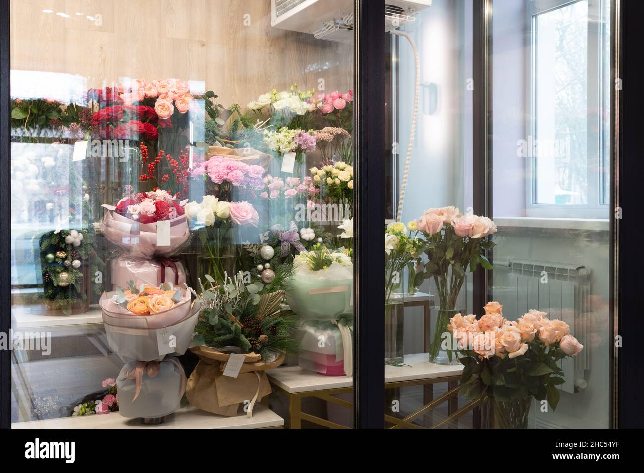 refrigerator in a flower shop with bouquets on the shelves Stock Photo