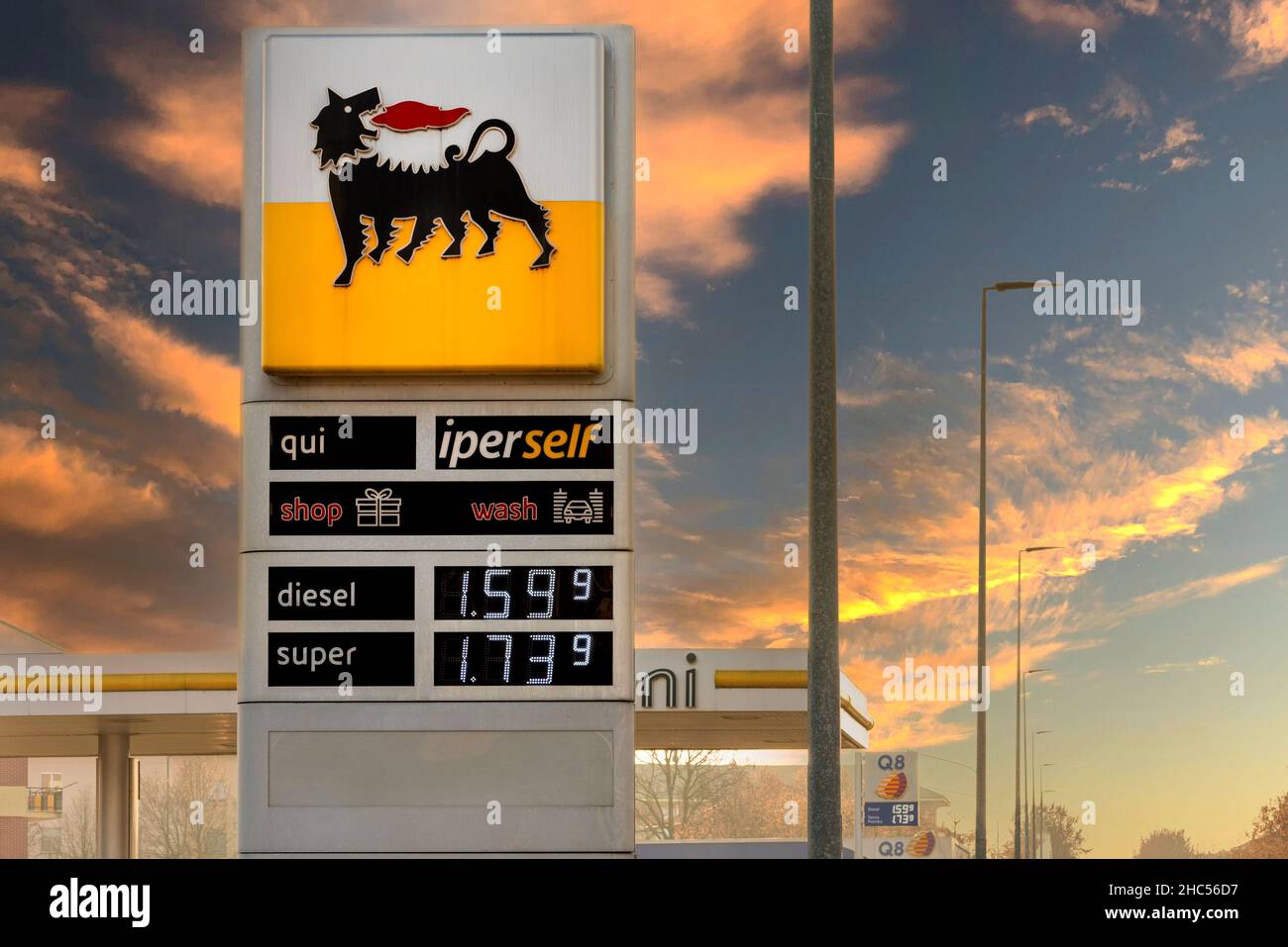 Fossano, Italy - December 23, 2021: Eni logo sign with fuel price display on sunset sky, Eni S.p.a is an Italian oil company worldwide. Expensive fuel Stock Photo