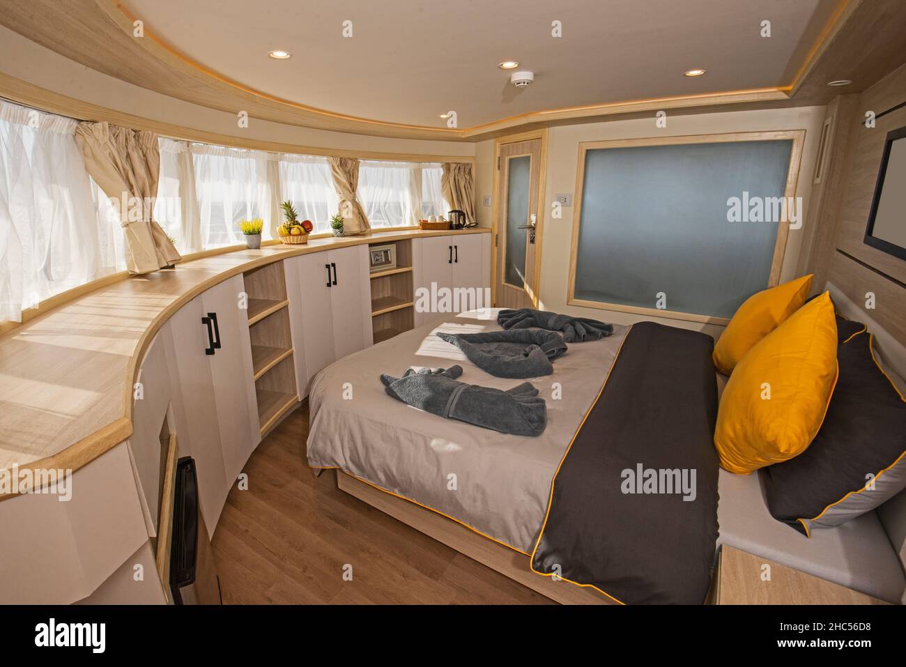 Interior of large suite cabin bedroom on luxury sailing yacht with ...
