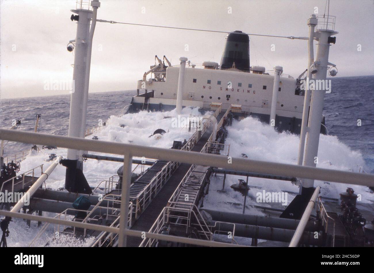 S.S. Texaco Brisbane at sea, looking aft in rough weather. Those of us living in the forward accommodation (Captain, Deck Officers and Radio Officer) had to walk down the catwalk to the other accommodation (shown)  for our meals. The ship was built in 1960 and scrapped in 1977. Photo taken in 1972. Stock Photo