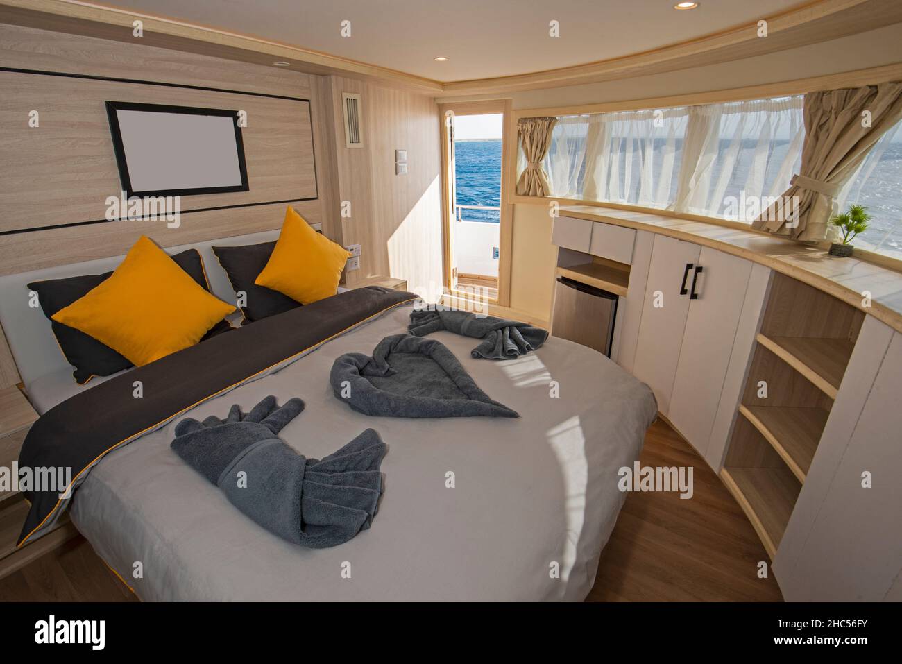 Interior of large suite cabin bedroom on luxury sailing yacht with ...