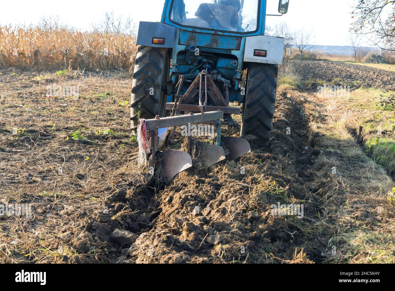 Agricultural machinery works of tractor working at a field Stock Photo