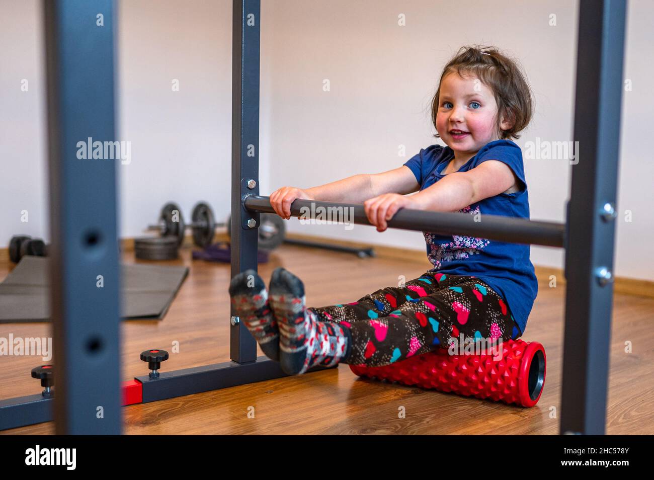 A fouryearold girl is doing calisthenics workout in home gym Stock Photo Alamy