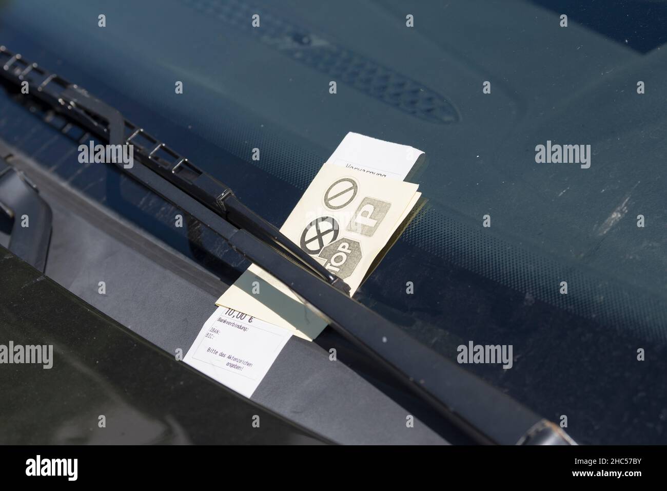 Parking ticket behind the windshield wiper Stock Photo