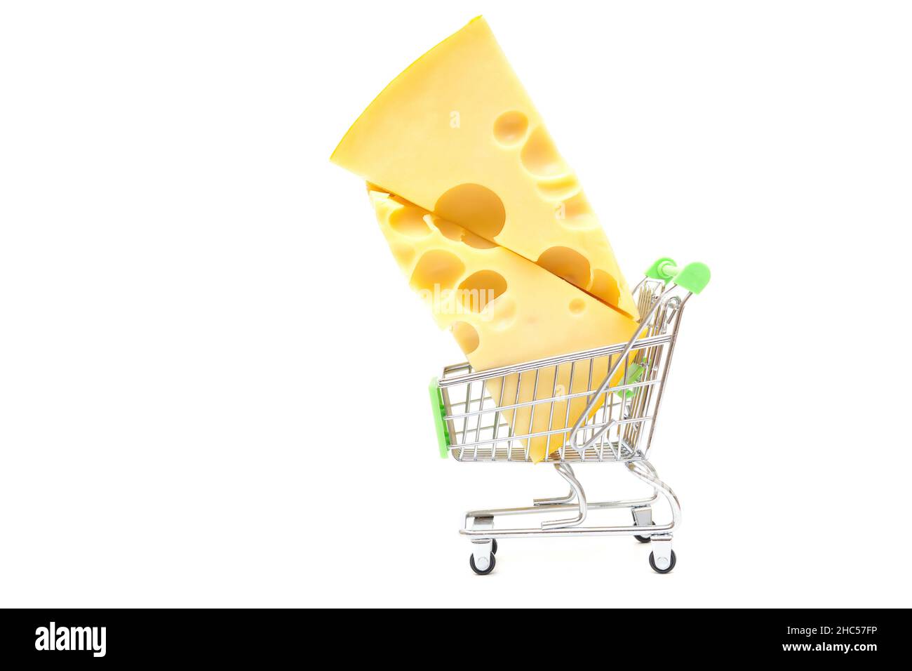 Two big holes cheese wedges in a miniature push cart isolated on white