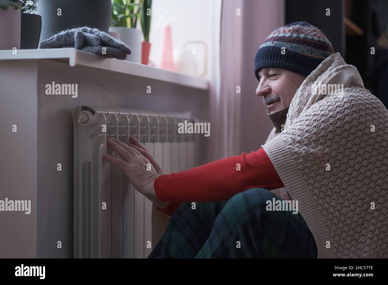 Man feeling cold at home with home heating trouble Stock Photo