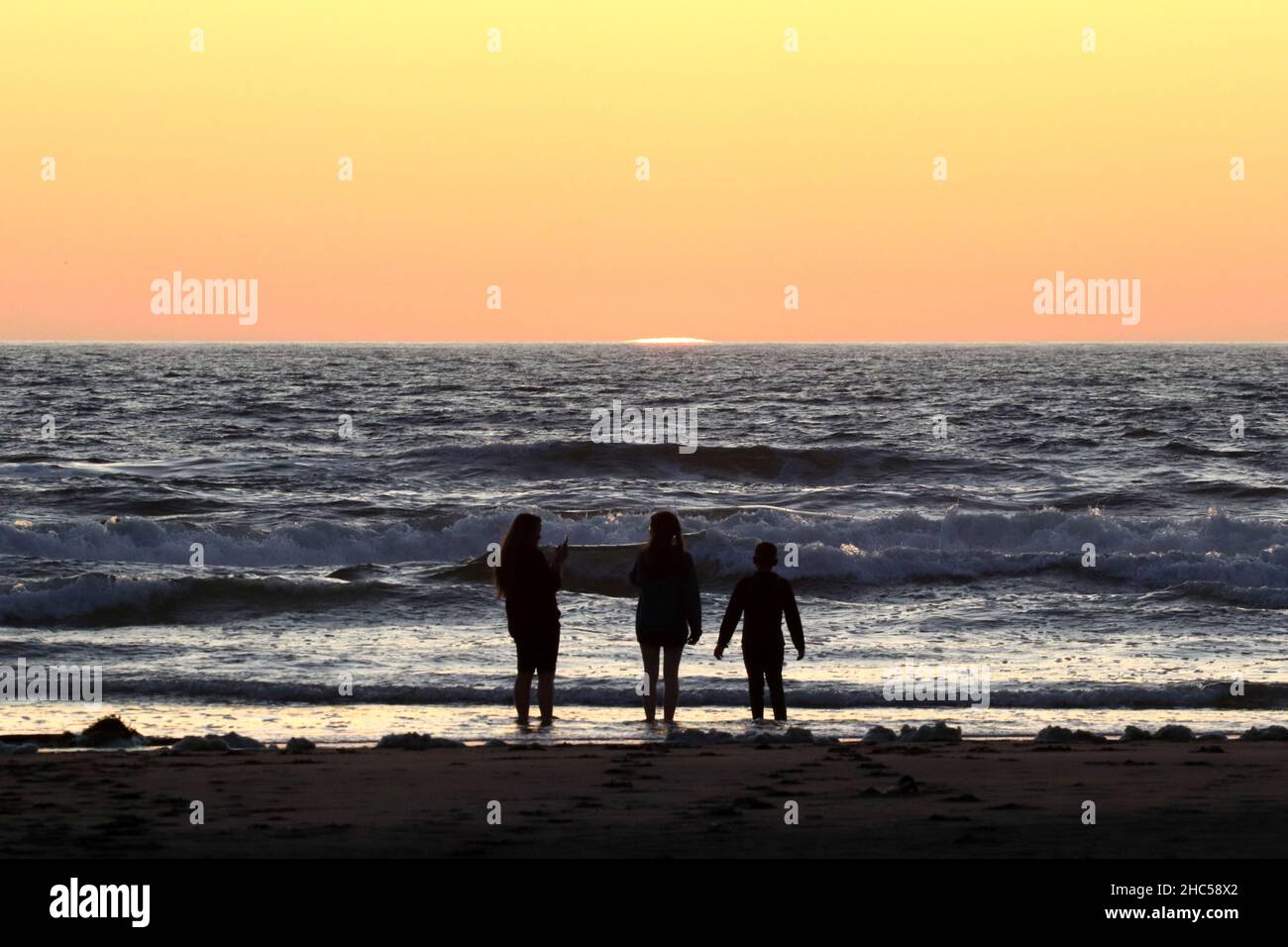 Happy family standing on a beach hi-res stock photography and images ...