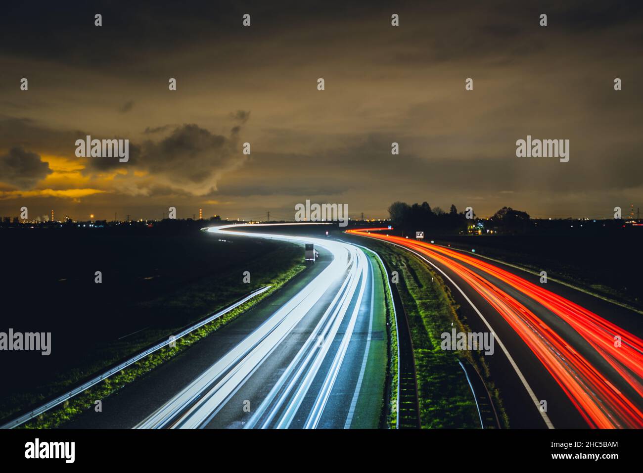 Aerial view of highways with illuminated red and white lights at night