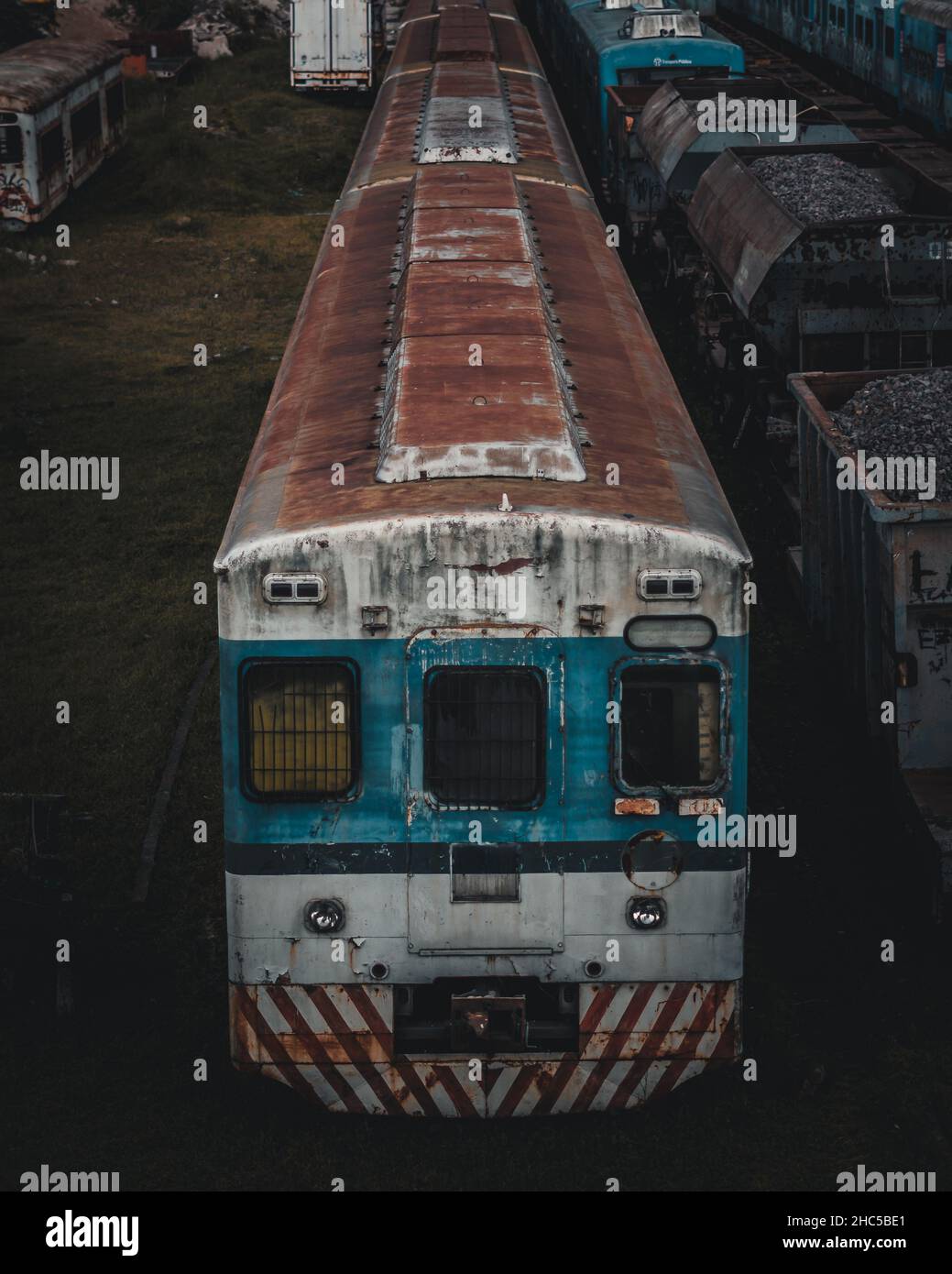 Vertical shot of an old train and freight cars at night Stock Photo
