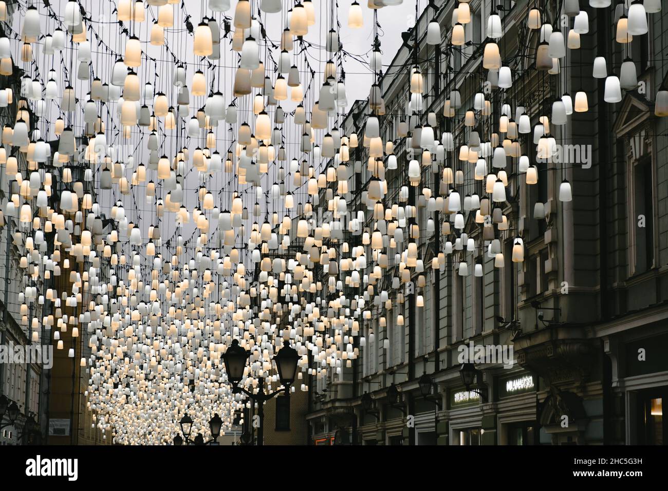 A beautiful street decorated with lanterns. Decoration of the city for the new year. Stoleshnikov Lane, Moscow. High quality photo Stock Photo