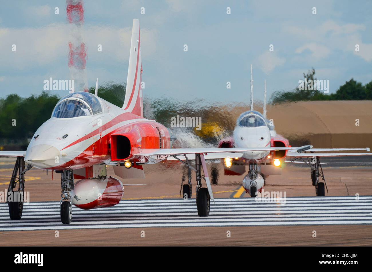 Patrouille Suisse, Swiss display team fighter jet planes arriving at Royal International Air Tattoo, UK, RAF Fairford. Taxiing jets creating heat haze Stock Photo