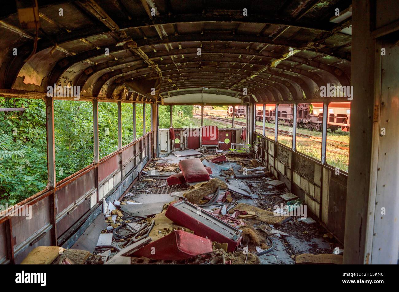 Demolished interior of abandoned rail bus wagon Stock Photo