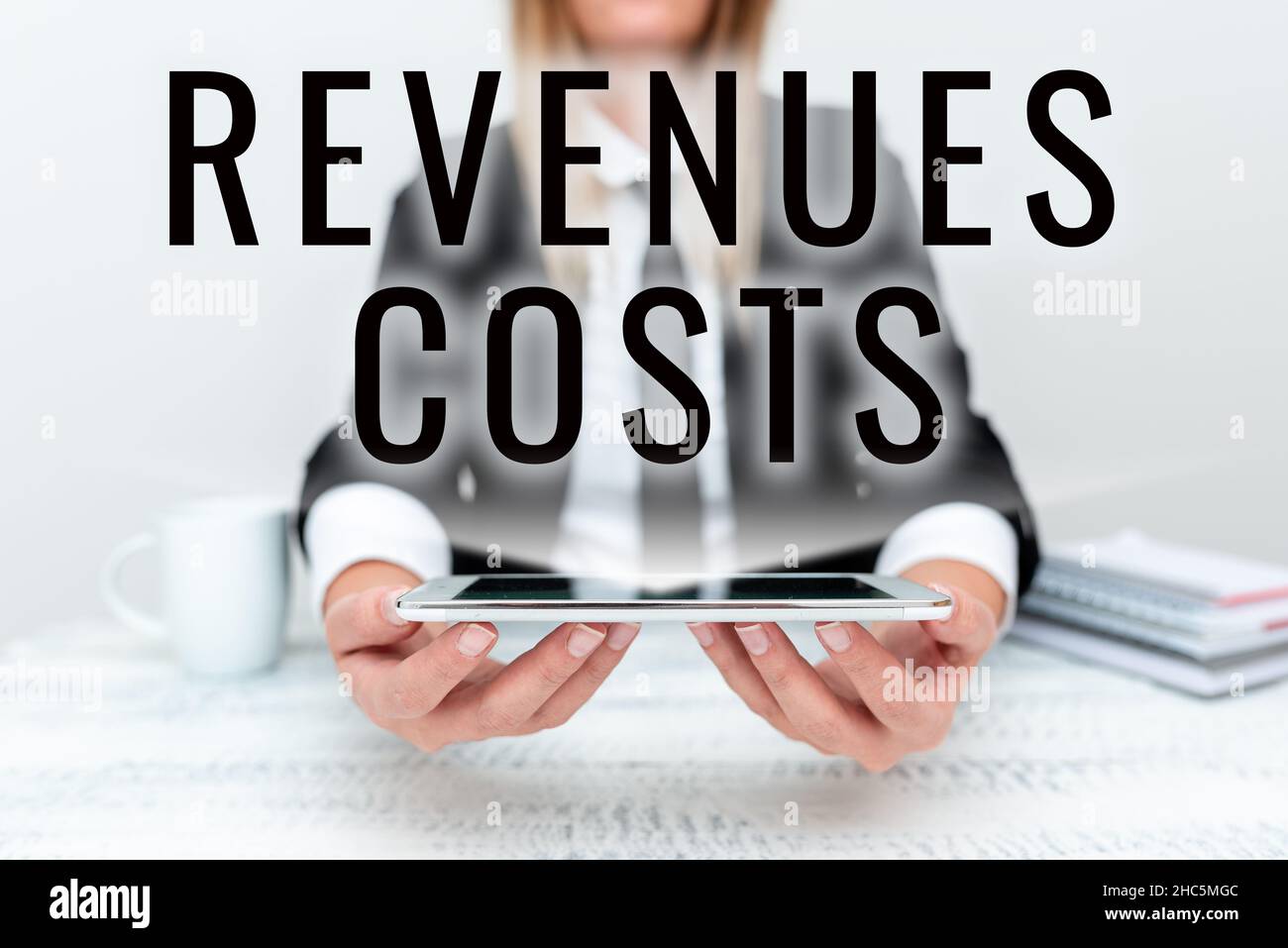 Conceptual caption Revenues Costs. Concept meaning Total amount of money in Manufacturing and Delivery a product App Developer Presenting New Program Stock Photo