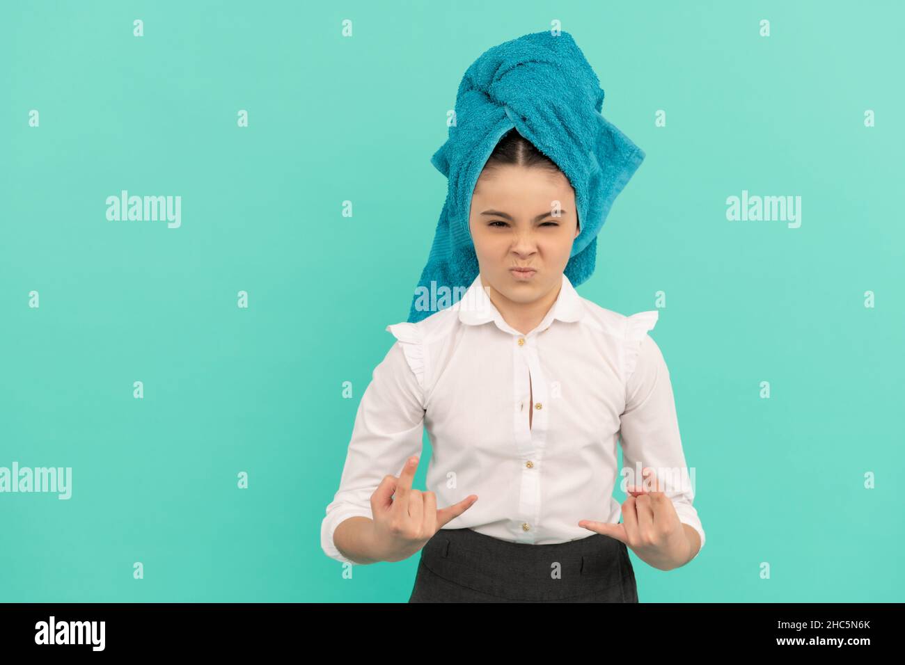 child in towel after shower. young girl on blue background. daily habit and personal care Stock Photo