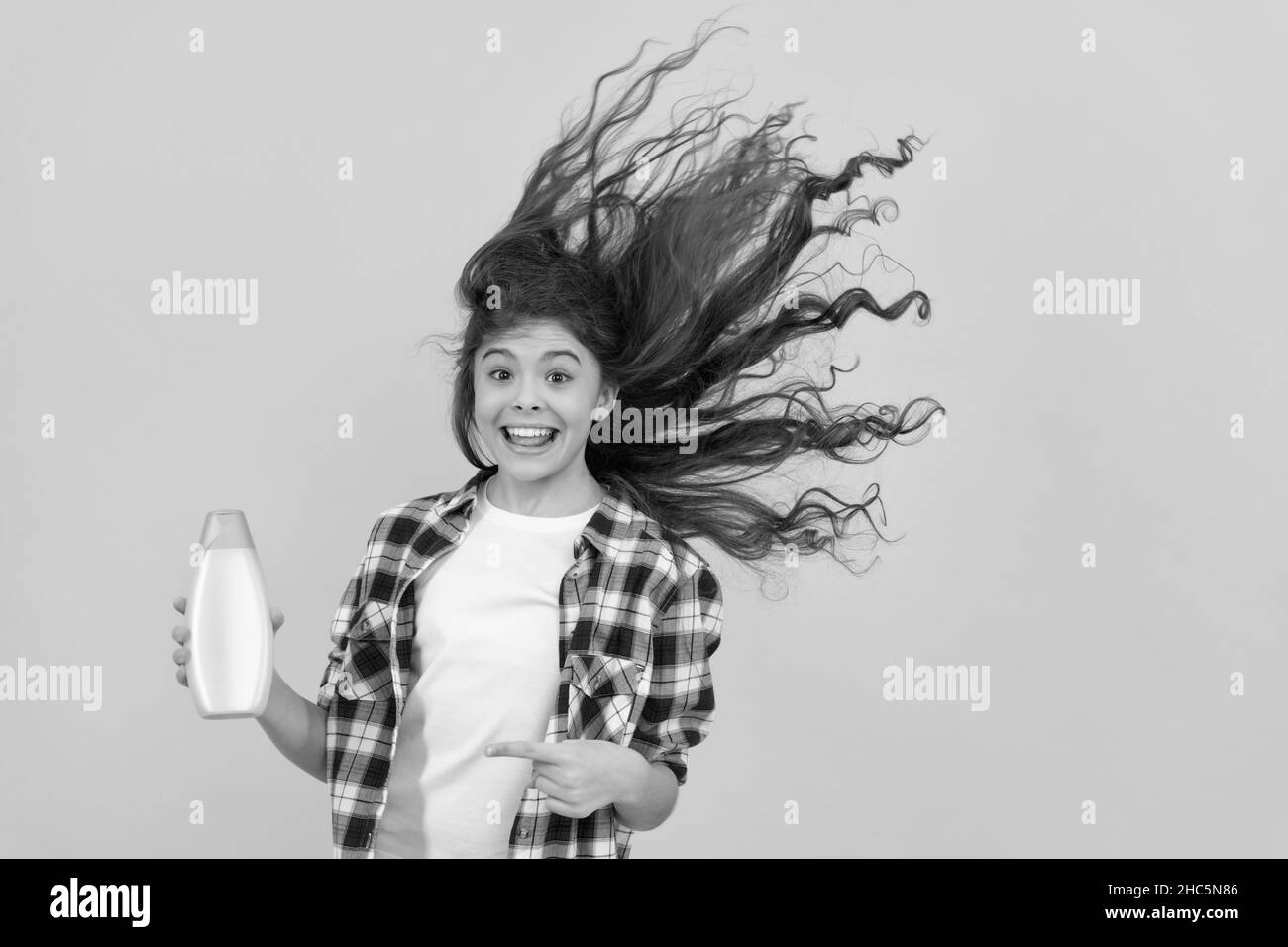 kid use shower gel. happy teen girl with shampoo bottle. shampooing