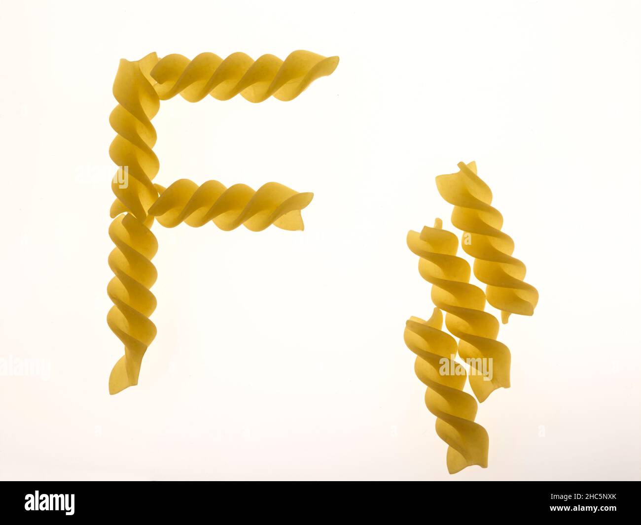 Macro food still life of Fusilli, fuˈzilli, pasta on plain background