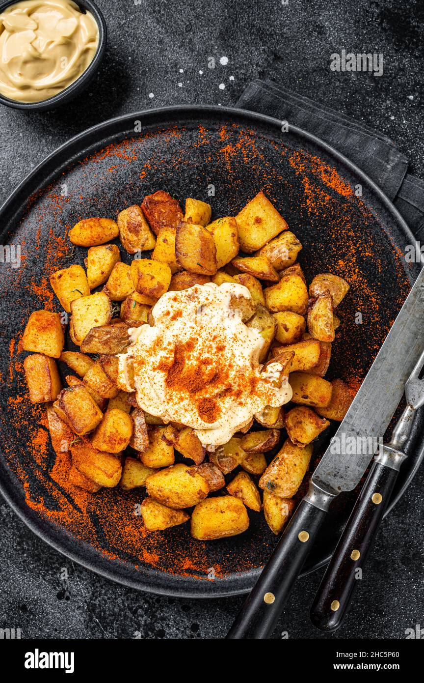 Patatas Bravas, traditional Spanish tapas, baked potato with spicy