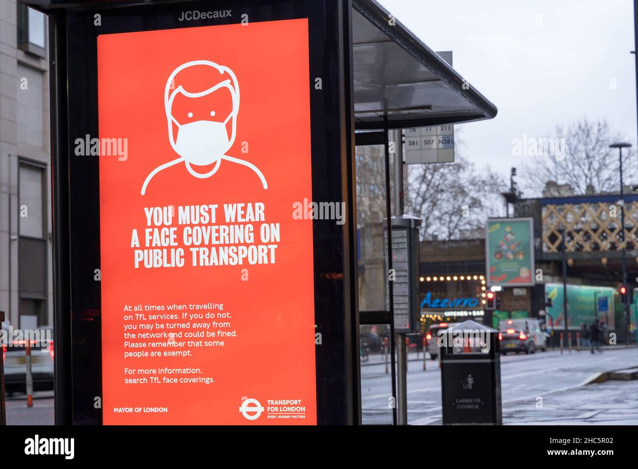 Transport for LONDON TFL advertising You must wer a face covering on public transport' on JCDecaus LED screen on road side England UK Stock Photo