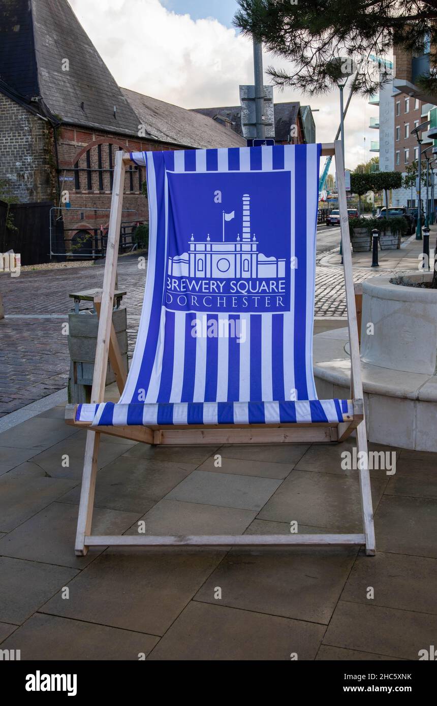 Vertical shot of a blue and white striped lounge chair in the redeveloped Brewery Square Stock Photo