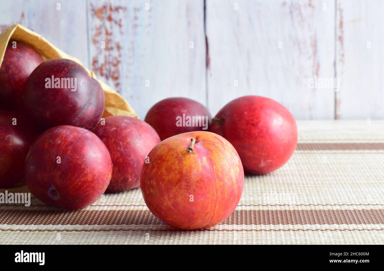 Closeup shot of red apples scattered out of a bag Stock Photo