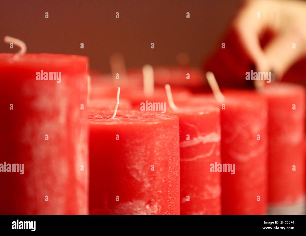 Kempen, Germany. 22nd Dec, 2021. Candles are polished for sale by an  employee at the manufacturer Engels Kerzen . During the Corona period,  candle manufacturers in North Rhine-Westphalia experience significantly  more demand.