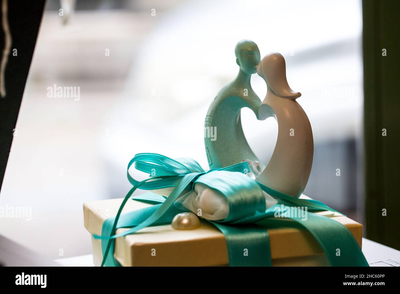 Close-up shot of a present box and figure of a couples kissing on it Stock Photo